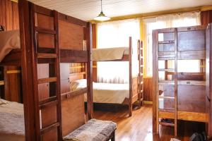 a room with two bunk beds and a window at 13 Lunas Hostel in Ancud