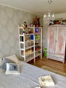 a bedroom with a bed and a dresser at Wind Rose apartment in Kuressaare +20 photos