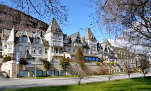 a large white building with pointed roofs on a street at Fleischer's Hotel in Vossevangen