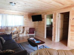 a living room with a couch and a table at Olympian Resort Motel in Diamond Point