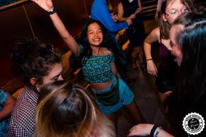 a young girl dancing in a crowd of people at Greg&Tom Beer House Hostel in Krakow