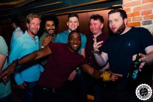 a group of men posing for a picture at a party at Greg&Tom Beer House Hostel in Krakow