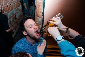 a man drinking from a glass of beer at Greg&Tom Beer House Hostel in Krakow