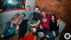 a group of people sitting on a couch giving thumbs up at Greg&Tom Beer House Hostel in Krakow