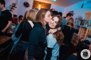 two girls hugging each other in a bar at Greg&Tom Beer House Hostel in Krakow