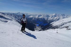 a person on skis standing on a snow covered mountain at Ferienhaus Rieger in Mallnitz