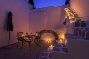 une salle à manger avec une table, des chaises et des lumières dans l'établissement RUSTIC SELF-INN, à Rhodes
