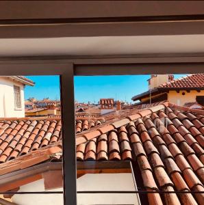 a view of a tile roof from a window at BLoft Charme&Relax in Bergamo