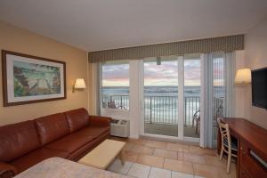 a living room with a couch and a view of the ocean at Westgate Harbour Beach Resort in Daytona Beach