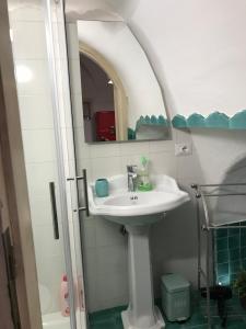 a bathroom with a sink and a mirror at Casa Cardi in Sperlonga