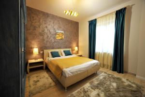 a bedroom with a bed and a large window at Like Home in Braşov