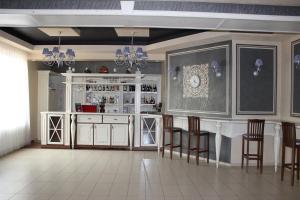 a bar with chairs and a counter in a room at Pid Yavorom in Ivano-Frankivsk