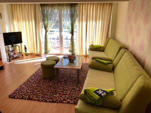 a living room with a couch and a table at Jezero Sniježnica - Vikendica in Sniježnica