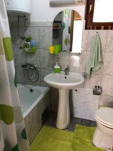 a bathroom with a sink and a tub and a toilet at Jezero Sniježnica - Vikendica in Sniježnica +66 photos