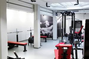 a gym with cardio equipment and a picture on the wall at Urban Trendy Nordic Living in Helsinki