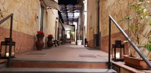 an alley way with vases and flowers in a building at Art & Jazz Hotel in Catania