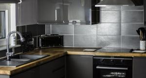a kitchen with a sink and a stove at Home Farm Apartments in Portree