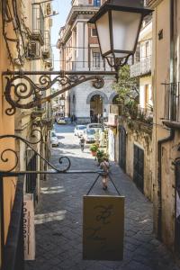 an alley with a sign on the side of a building at Futura Retrò in Salerno
