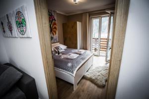 Posteľ alebo postele v izbe v ubytovaní Apartamenty przy skoczni