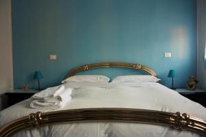 a bedroom with a large bed with blue walls at Home in Ravenna