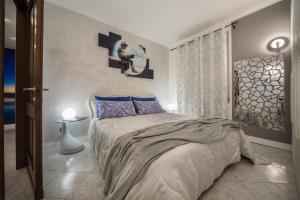 a bedroom with a large bed with blue pillows at Fall In Love with Como Lake in Bellano