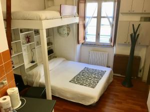 a bedroom with two bunk beds and a table at La GEMMA del Quadrilatero in Turin