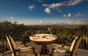 a table and two chairs on a deck with a view at Il Mulino della Signora Luxury country House in Frigento