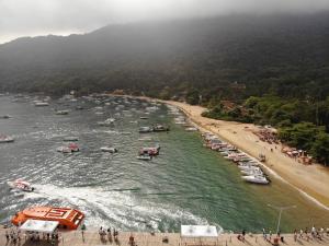 a group of boats in the water next to a beach at Pousada Agua Viva in Abraão