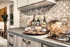 a tray of wine bottles and bread on a kitchen counter at Il Nido nel Chianti in Greve in Chianti