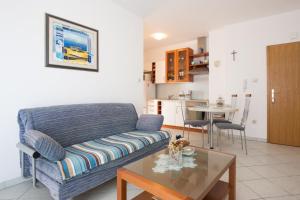 a living room with a couch and a table at Apartments in Vrbnik/Insel Krk 36771 in Vrbnik