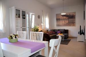 a kitchen and living room with a table and chairs at Holiday House Family Fun in Cesarica