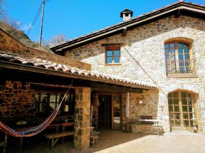 a large stone building with a patio in front of it at Bed&Breakfast la Cabanya de Beget in Beget
