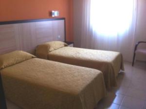 Postel nebo postele na pokoji v ubytování Hotel Giardino