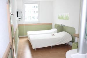 Posteľ alebo postele v izbe v ubytovaní Ibis budget Wien Messe