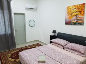 Katil atau katil-katil dalam bilik di Beautiful azelia elite guesthouse at bukit banyan sungai petani