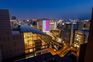 a view of a city at night with buildings at Hotel Okura Fukuoka in Fukuoka