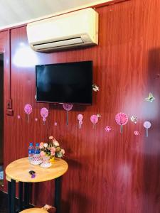 a room with a wall with pink umbrellas on it at Green Hill Hostel & Tour in Ha Giang