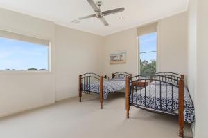 a bedroom with two beds and a window at Nautilus in Lakes Entrance