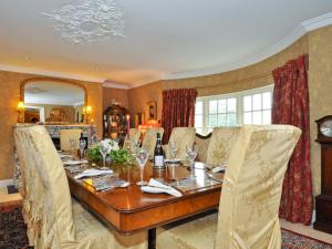 a dining room with a long table and chairs at Weir Haven Boutique Accommodation in Clarinbridge