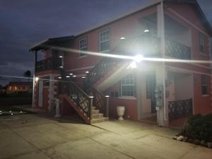 a house with a light on the side of it at Breezy Apts in Saint Philip