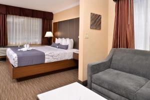 a hotel room with a bed and a couch at Best Western Hollywood Plaza Inn Hotel - Hollywood Walk of Fame LA in Los Angeles