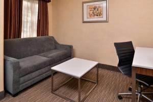 a living room with a couch and a table at Best Western Hollywood Plaza Inn Hotel - Hollywood Walk of Fame LA in Los Angeles
