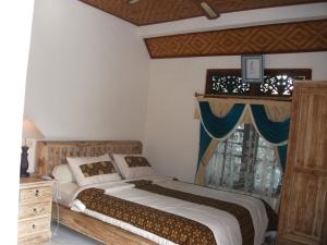 Postel nebo postele na pokoji v ubytování Arsa Homestay & Spa
