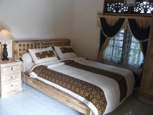 Postel nebo postele na pokoji v ubytování Arsa Homestay & Spa