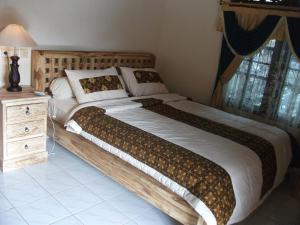 Postel nebo postele na pokoji v ubytování Arsa Homestay & Spa