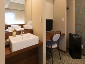 two pictures of a bathroom with a sink and a chair at S.Training Center Hotel Osaka in Osaka