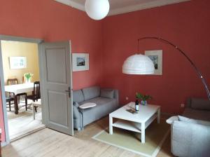 a living room with a couch and a table at Marstall im Schlosspark Rheinsberg in Rheinsberg