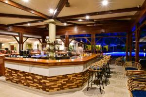 a bar in a restaurant with chairs and tables at Tarisa Resort & Spa in Mont Choisy