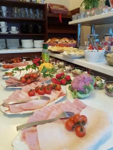 a table with many different types of meats and vegetables at U Gruloka in Poronin