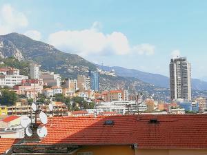 a view of a city with buildings and mountains at 6 Rue de Castillon Appartement in Beausoleil